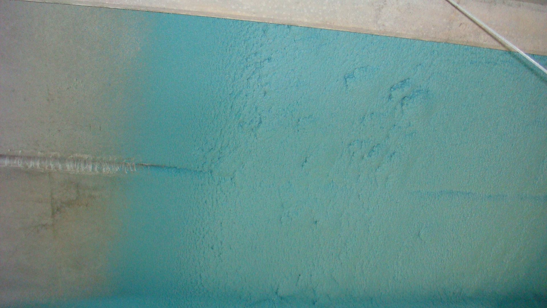 Plant structural steel receiving protective polyurea overcoat