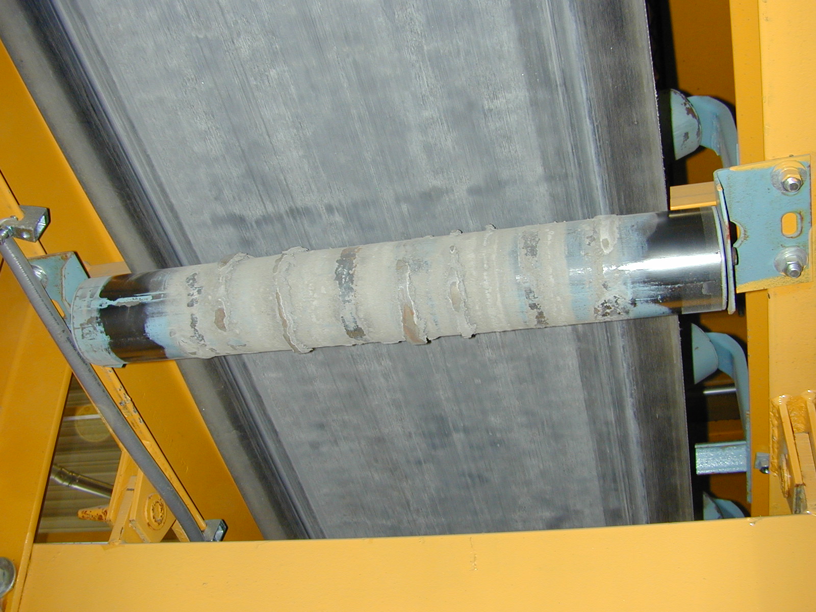 In-service conveyor structure with corrosion before maintenance overcoating