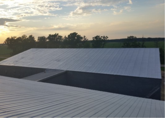 Aging metal roof protected with sprayed polyurea membrane